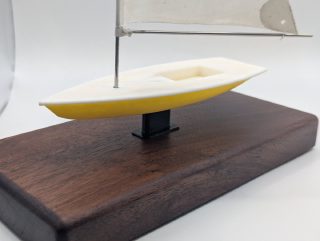 Detail of a Laser/ILCA sailboat award showing hull and mast