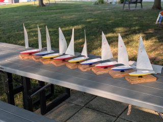 All sailboat awards laid out on a table outdoors