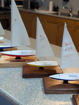 Close-up of three sailboat awards with dacron sails marked 1st, 2nd, 3rd