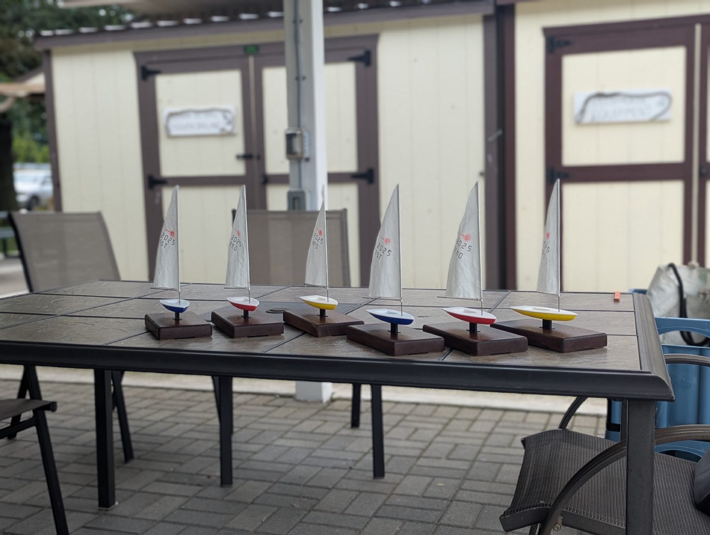 Group of Laser/ILCA model sailboat awards in several hull colours