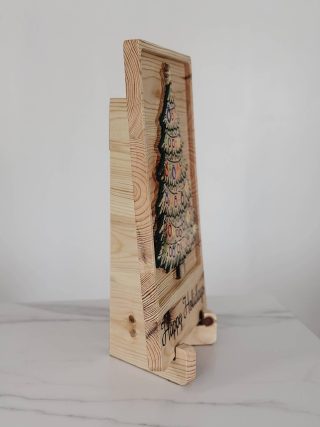 Holiday sign standing upright on its hinged folding stand