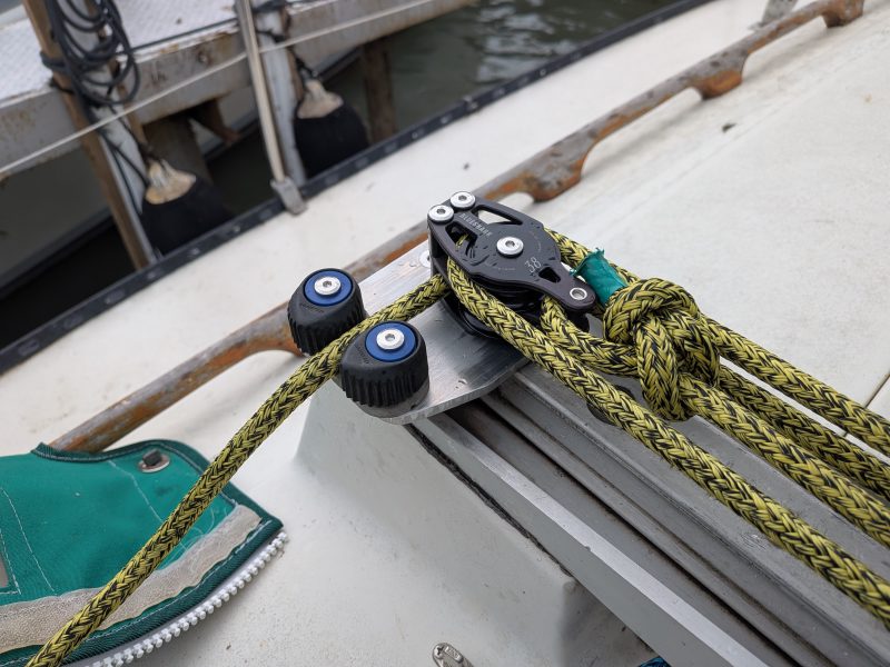 Custom aluminium traveller plate installed on a sailboat with blocks and control lines