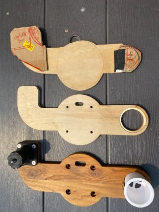 Binnacle mount progression from cardboard template to raw cut to finished teak piece