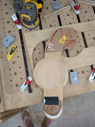 Binnacle mount being CNC cut with cardboard template alongside