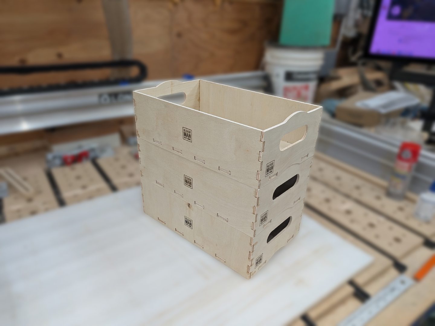 Three project boxes stacked, showing the handle cutouts and tab joinery