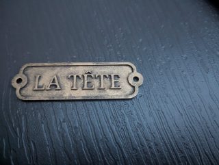 Plastic door label with decorative border and screw mounting holes